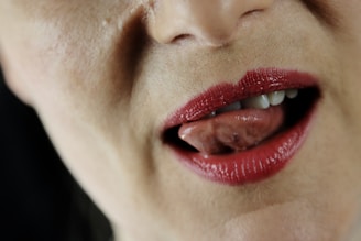 Close-up of crimson lips parted slightly, hinting at whispered secrets.