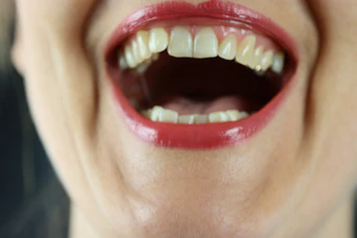 A close-up of a woman’s lips with a playful, inviting smile.