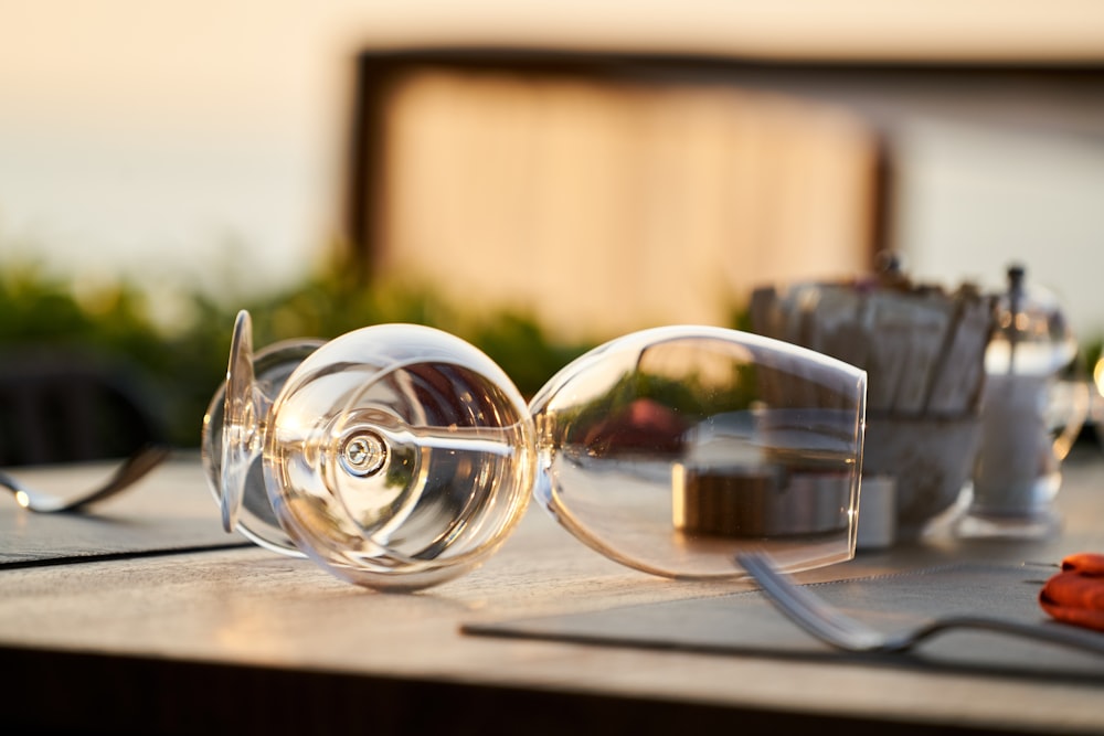 2 clear glass ball decors on brown wooden table