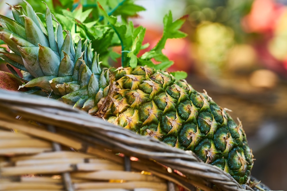 green pineapple fruit on brown woven basket