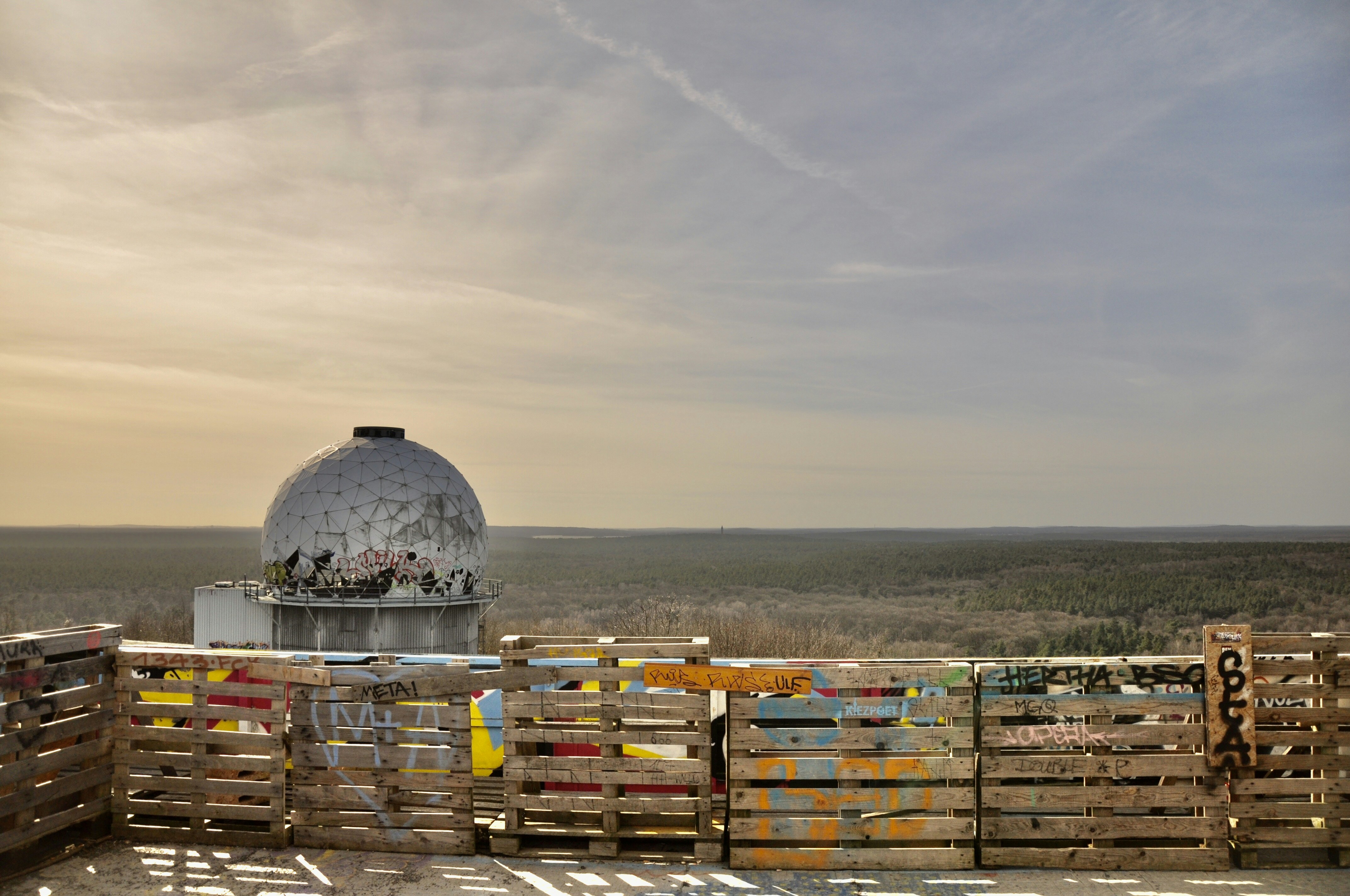 white and brown wooden boxes on beach shore during daytime