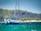 Sailboat anchored in a turquoise Ionian bay with a 3D printed replacement part installed on the rigging.