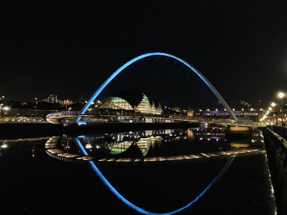 lighted bridge over river during night time