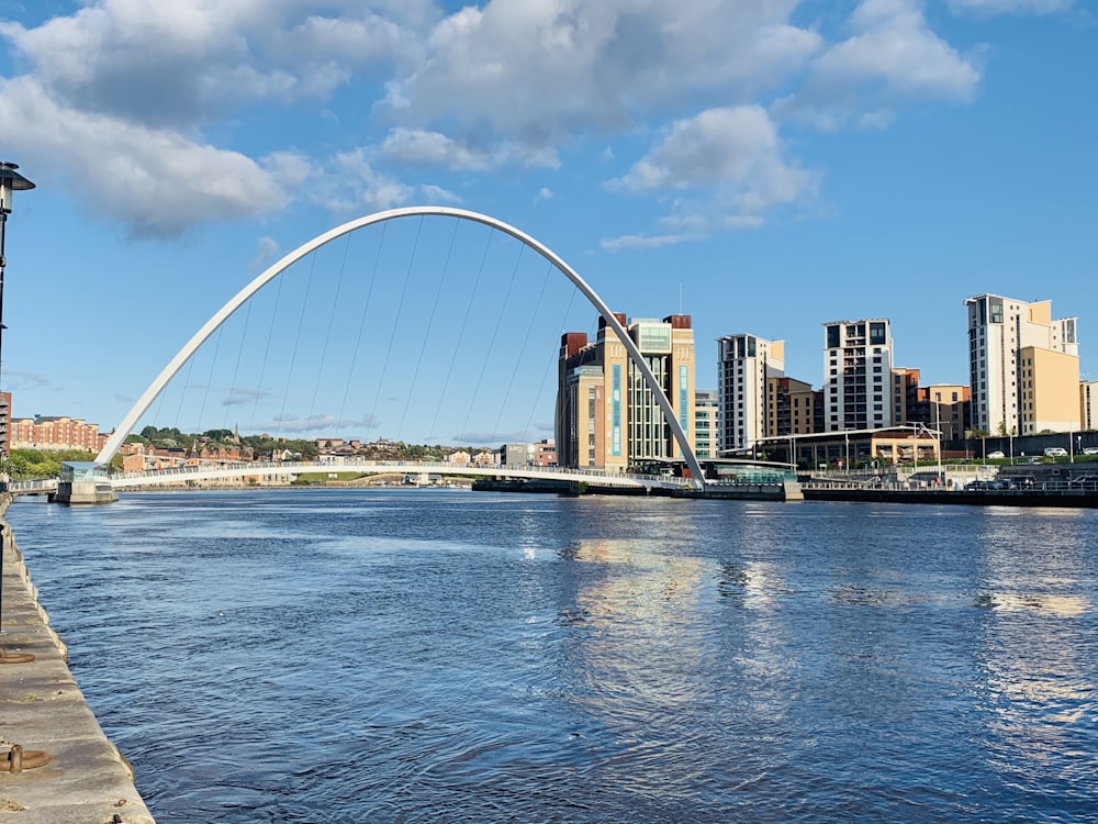 white and blue bridge over blue sea under blue sky during daytime