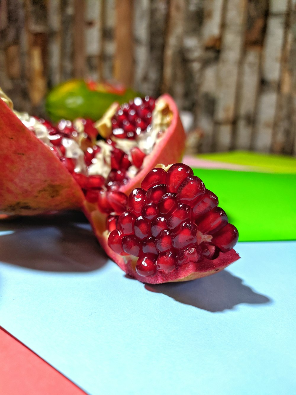 sliced pomegranate fruit on white table