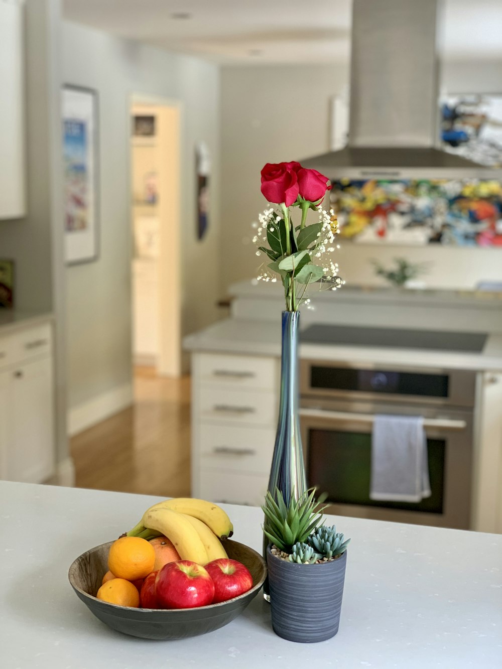 red rose in clear glass vase on white table