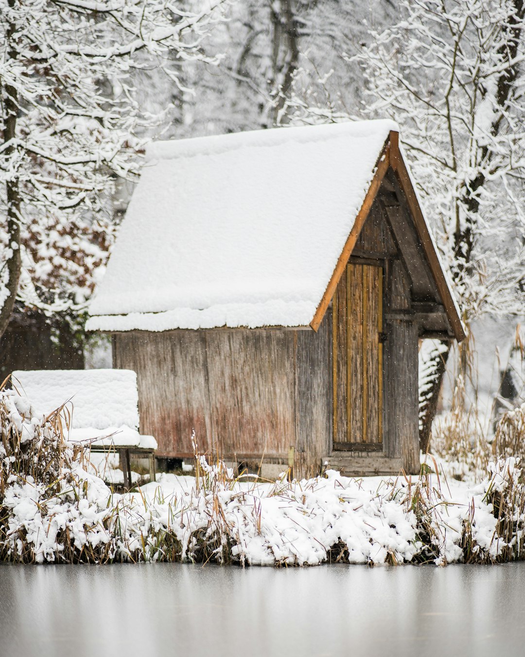 brown wooden house covered with snow