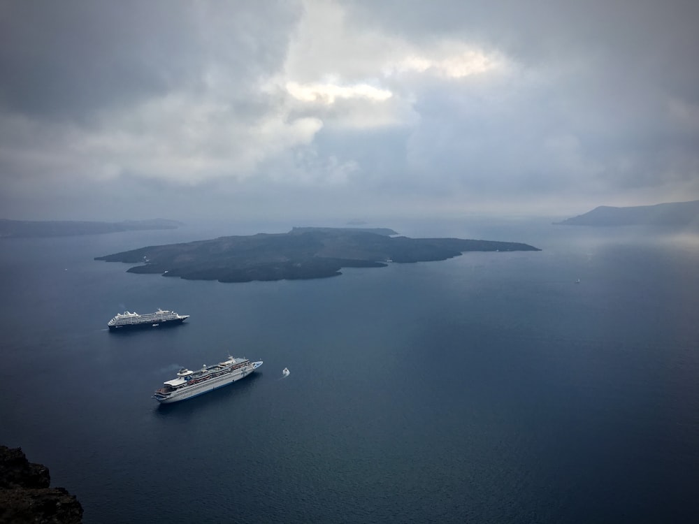 white boat on sea under cloudy sky during daytime