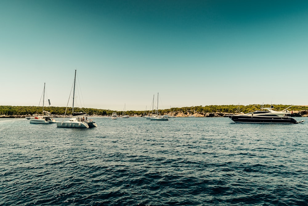 white boat on sea during daytime