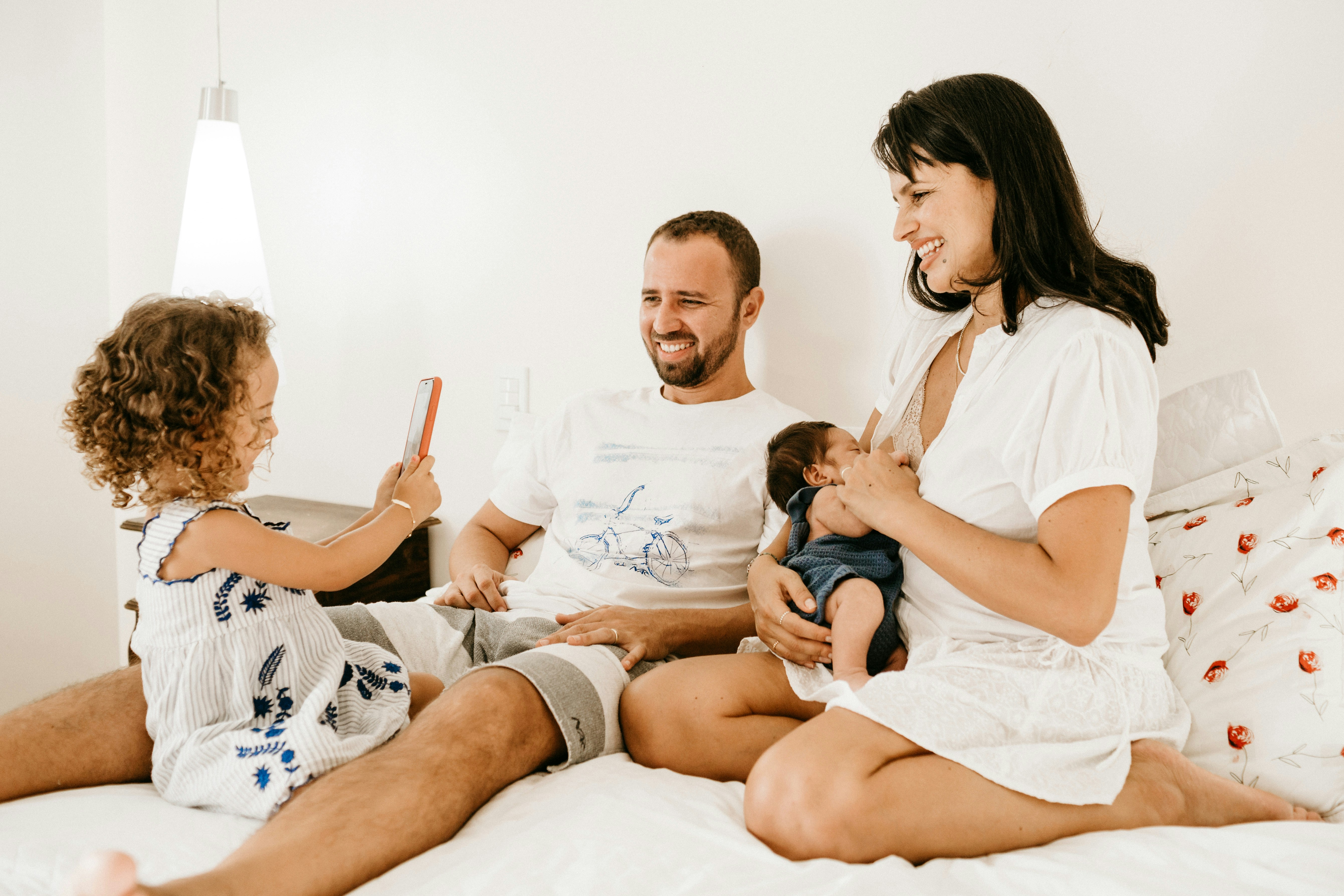 Happy family chilling on bed