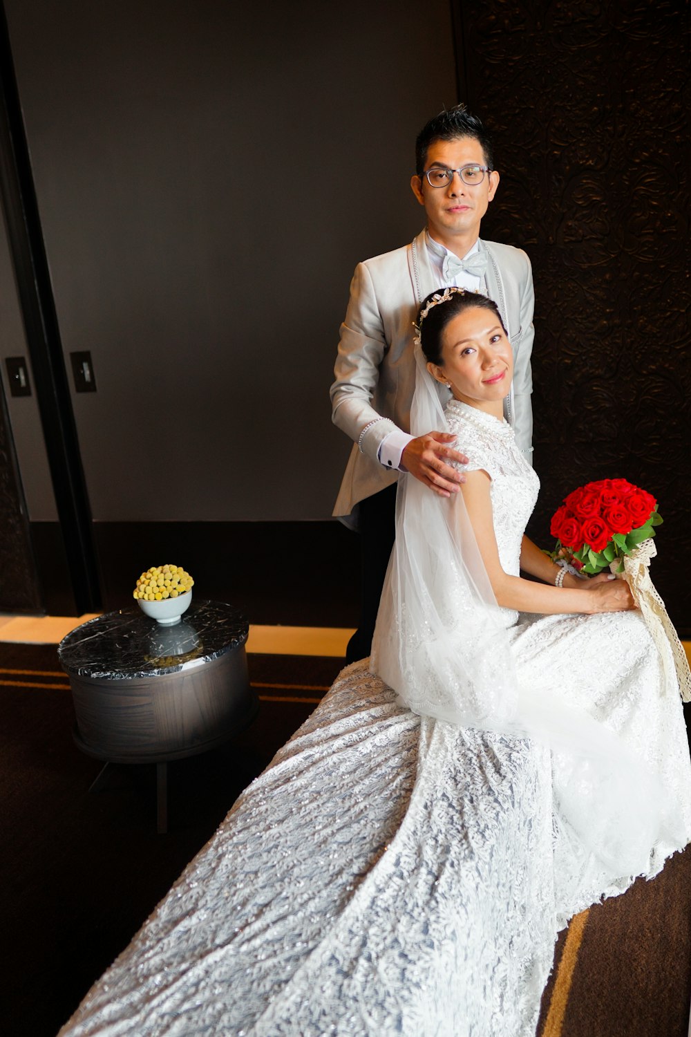 woman in white wedding gown holding bouquet of flowers