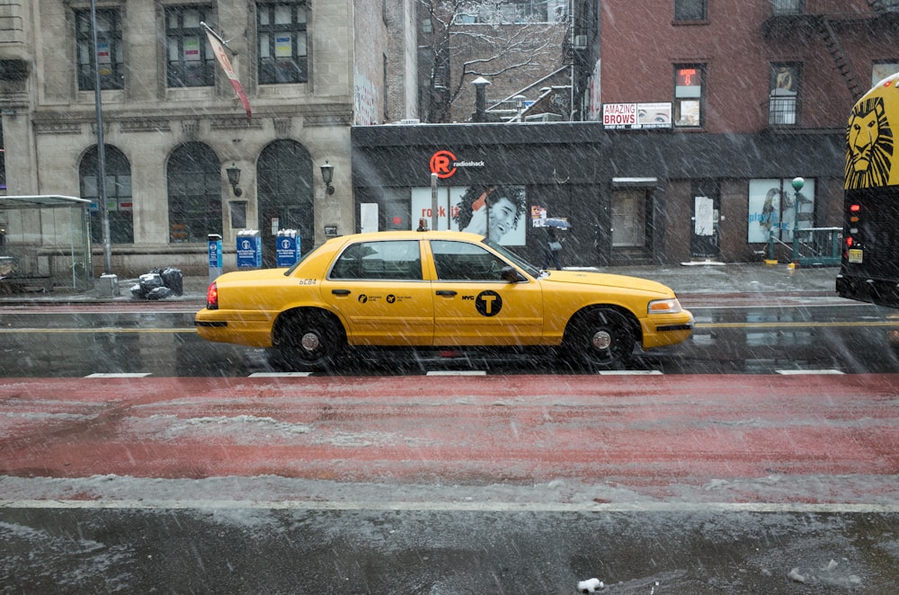 yellow cab on road during daytime