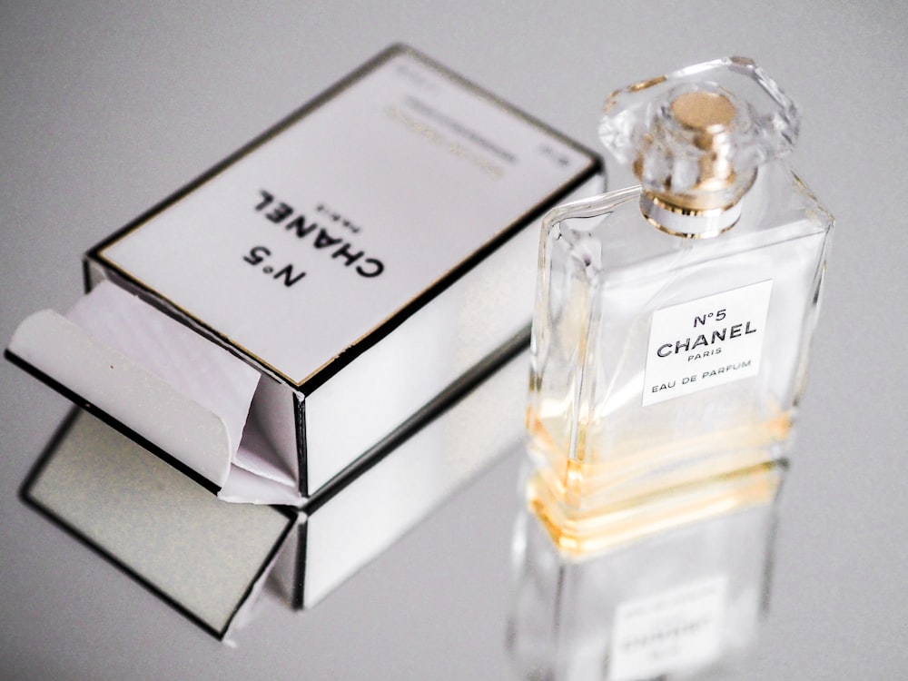 white and black labeled perfume bottle photo – Free Perfume Image on ...