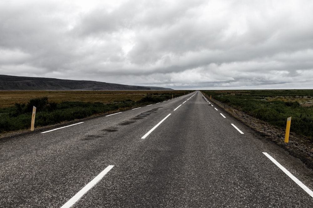 gray asphalt road under gray cloudy sky during daytime