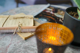 A cozy stack of carefully wrapped book bundles tied with twine, resting on a soft linen cloth.