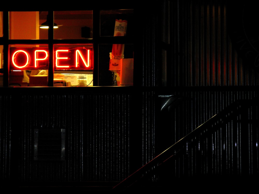 red and black open neon light signage