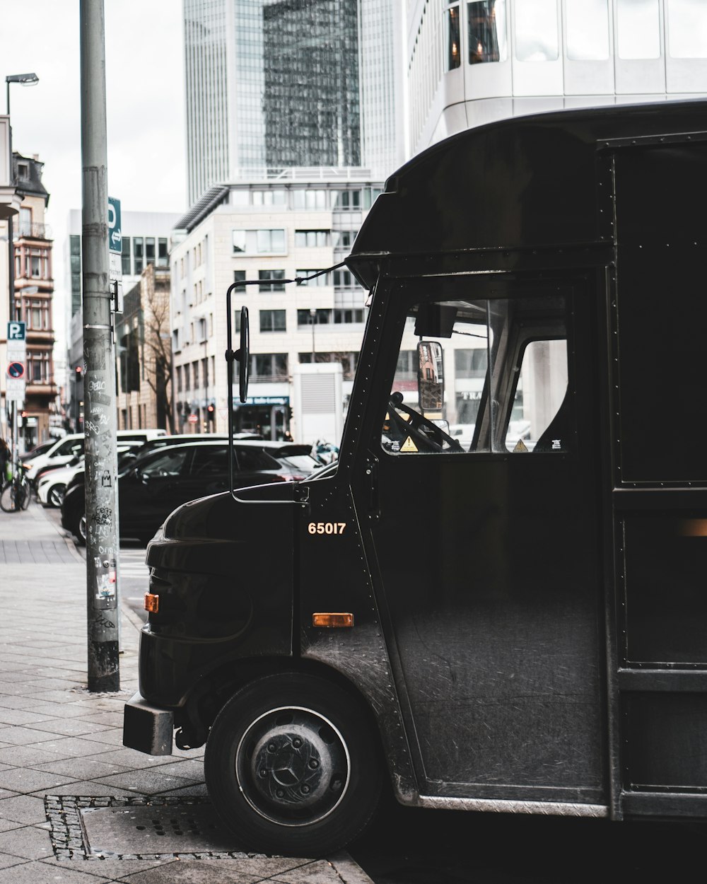 black van on the street during daytime