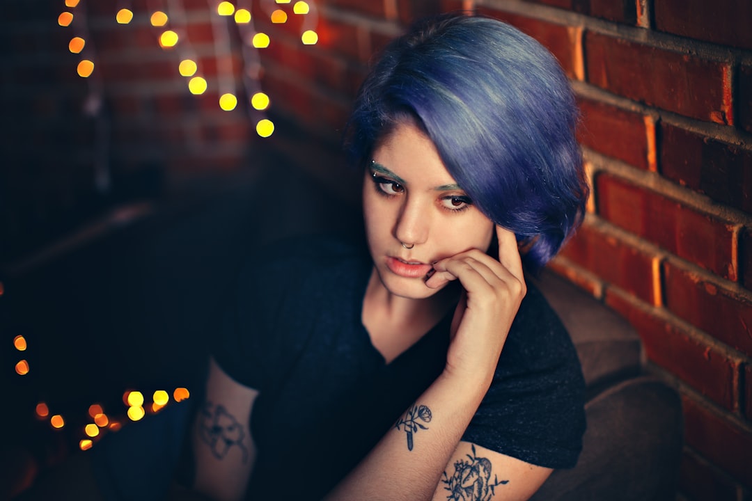 woman in black shirt with black tattoo on left hand