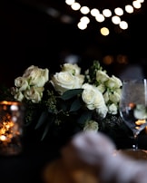 Romantic anniversary setup with delicate fairy lights and elegant floral centerpieces in gold and white.