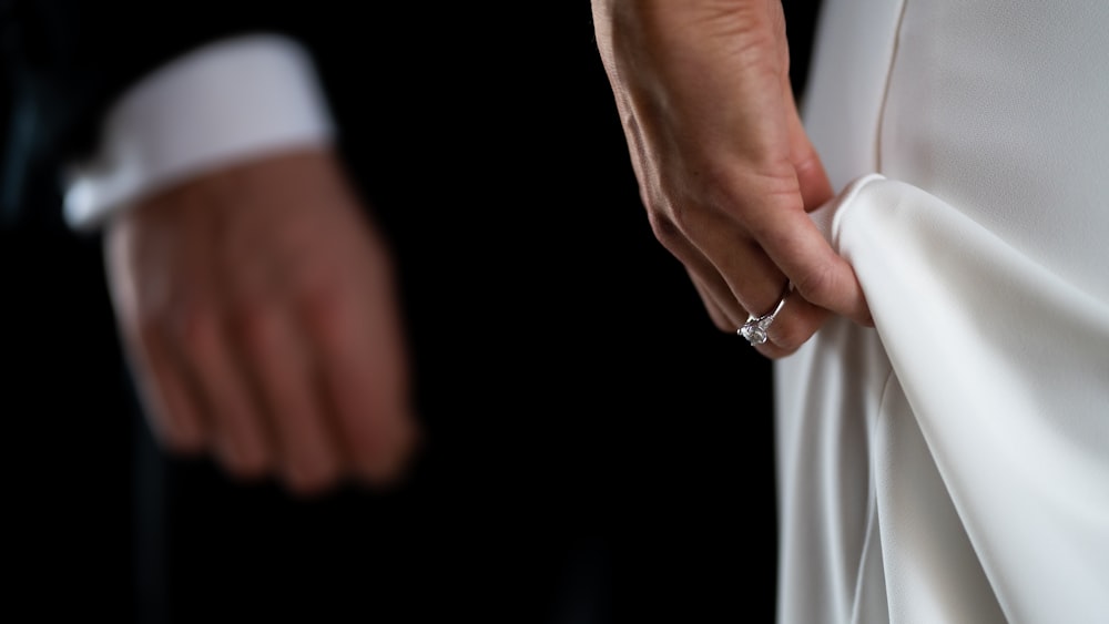 person wearing silver diamond ring