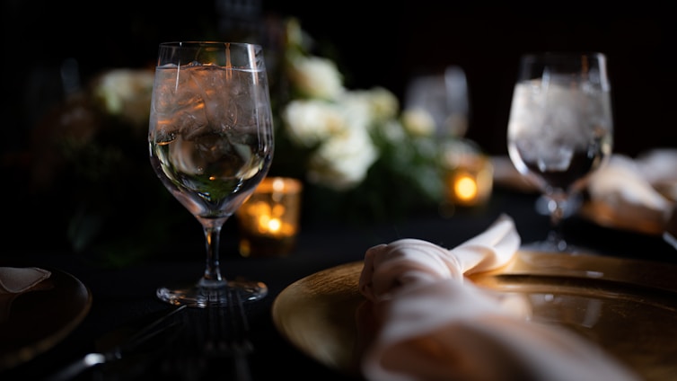 A serene table setting featuring elegant glassware filled with clear water, surrounded by gourmet dishes.