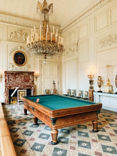 brown wooden billiard table near brown wooden chair