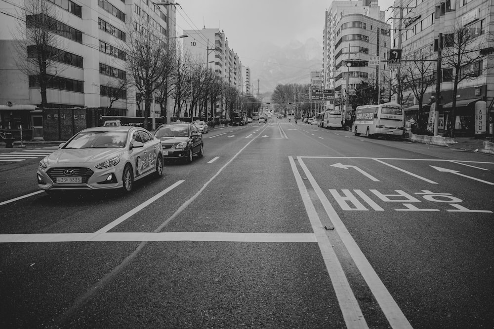 grayscale photo of cars on road