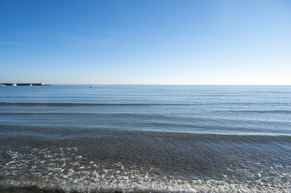 blue ocean under blue sky during daytime