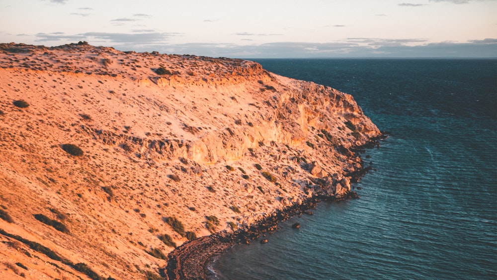 a cliff with a body of water in the middle of it