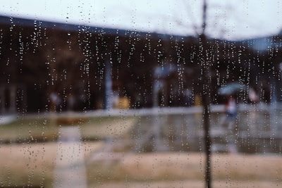 An outdoor scene showing a protected surface during a rainstorm, demonstrating effectiveness.