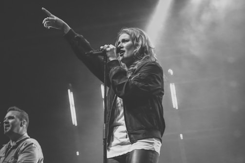 A dynamic artist performing on stage with passion.