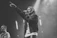 A joyful singer passionately performing with a microphone on stage.