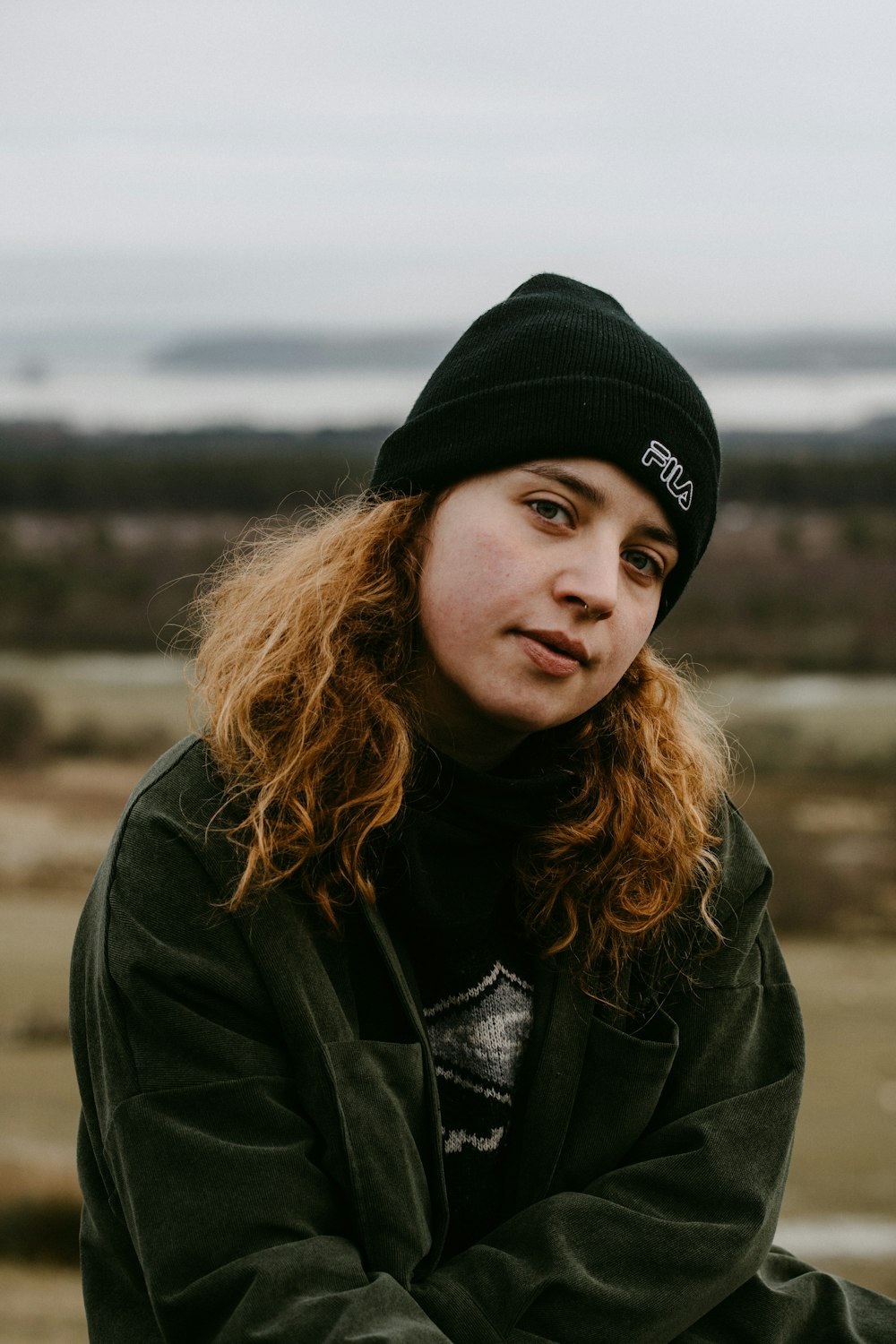 woman in black knit cap and black jacket