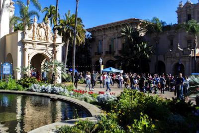 A vibrant courtyard scene with students and startup founders collaborating under the California sun.