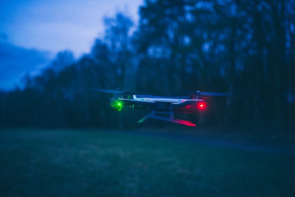 green and black drone flying on mid air during daytime