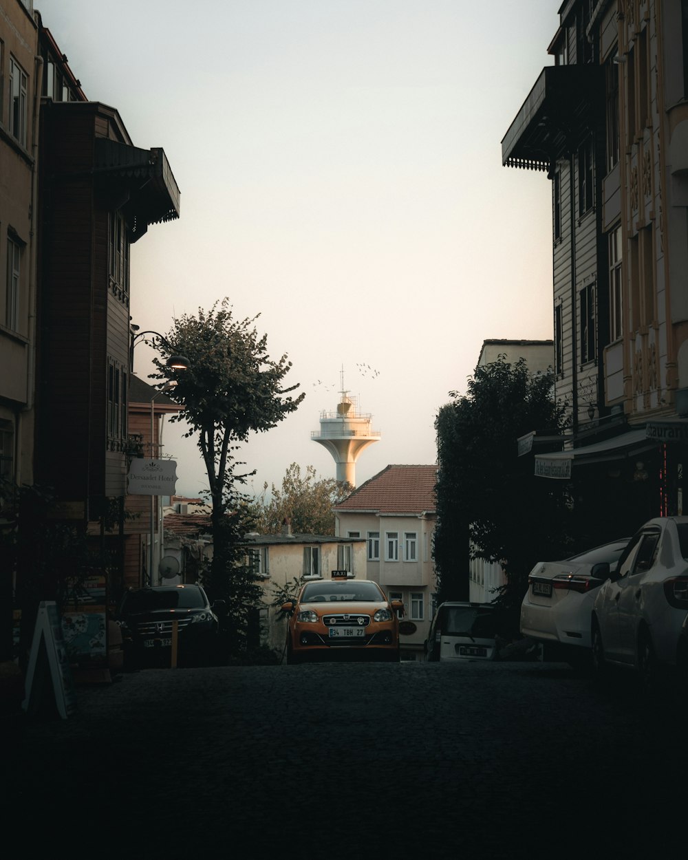 cars parked on side of road near building during daytime