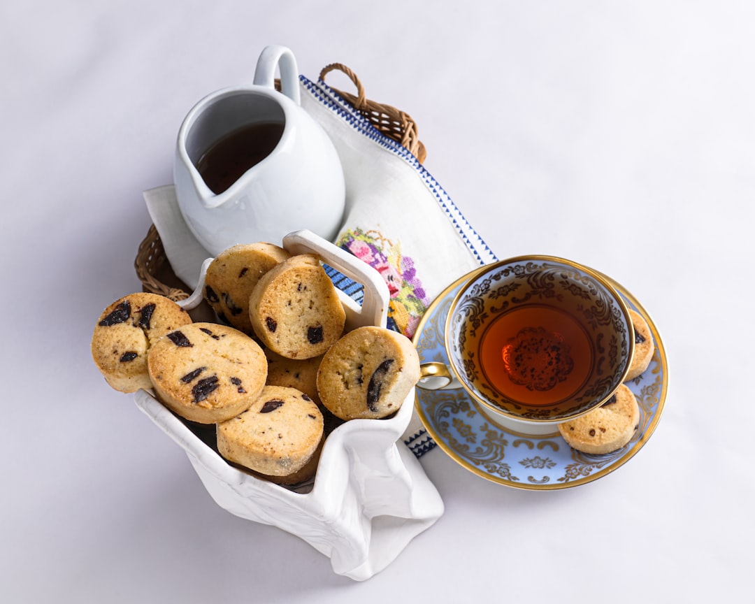 brown bread on white ceramic plate beside white ceramic teacup