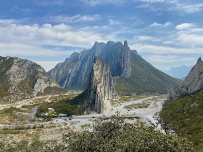green and brown mountain under white clouds during daytime