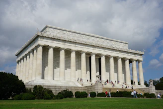 people in front of white concrete building during daytime