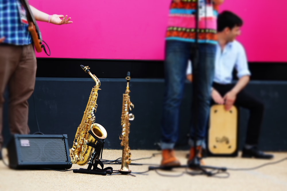 person in blue denim jeans playing saxophone
