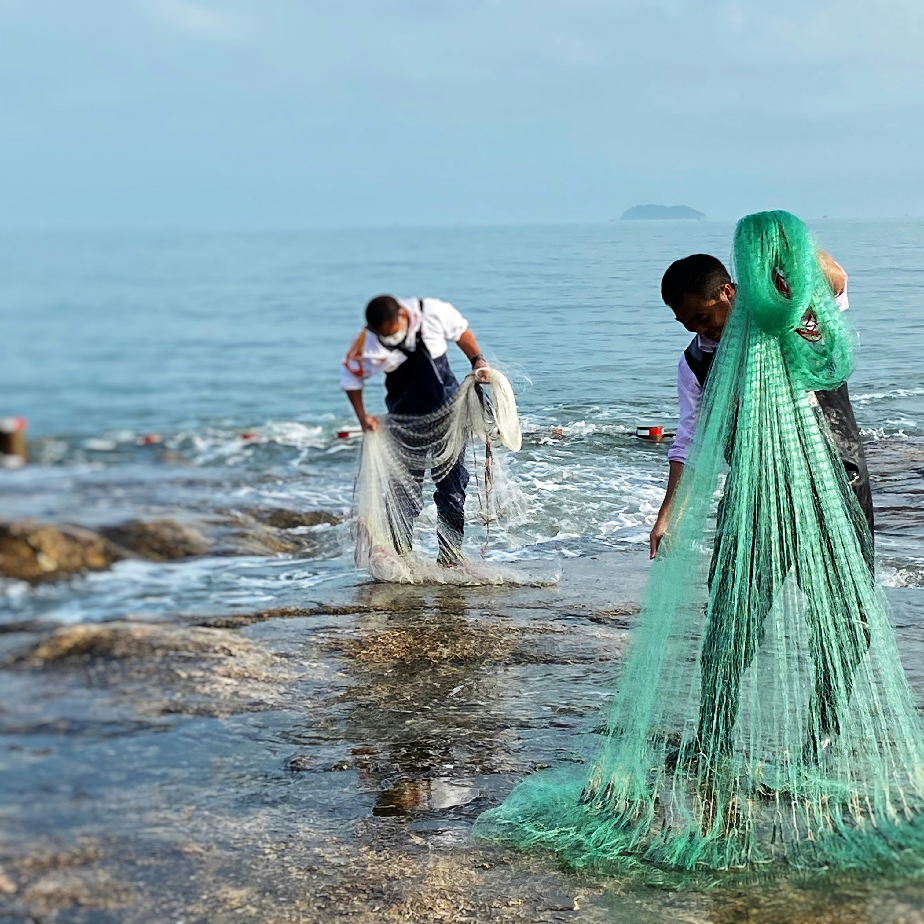 woman in green dress standing on beach during daytime