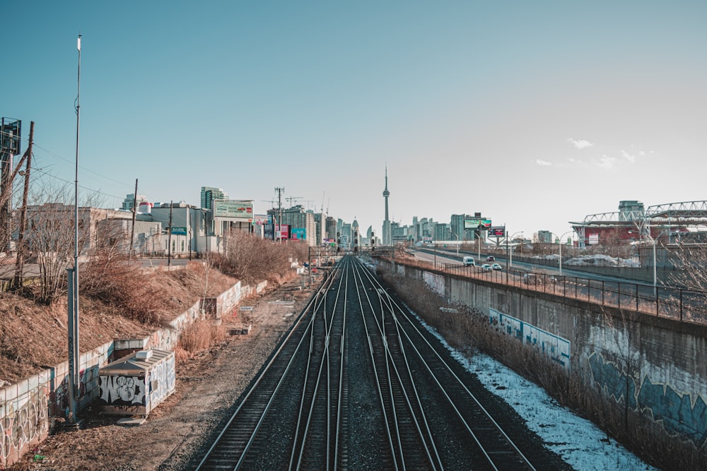 train rail near houses during daytime