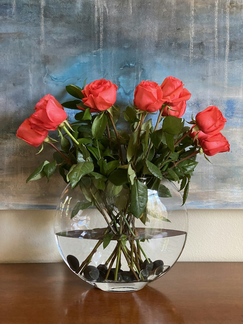 red roses in clear glass vase