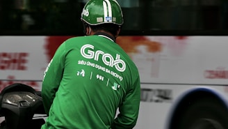 man in green and white UNK UNK long sleeve shirt wearing red helmet