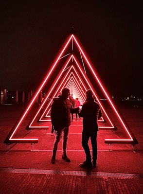 man and woman walking on the street during night time
