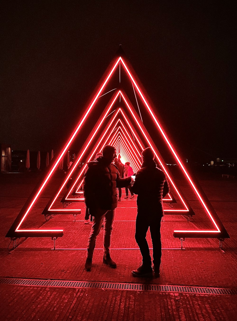 man and woman walking on the street during night time