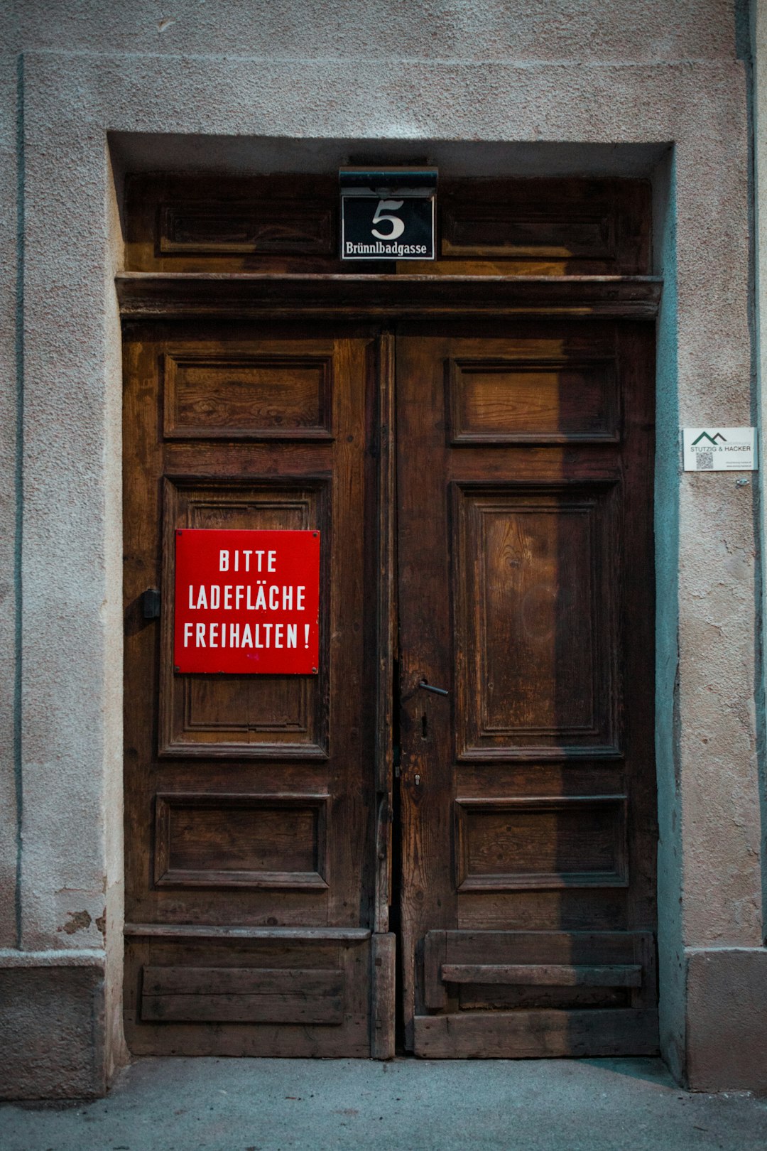 brown wooden door with red and white no smoking sign