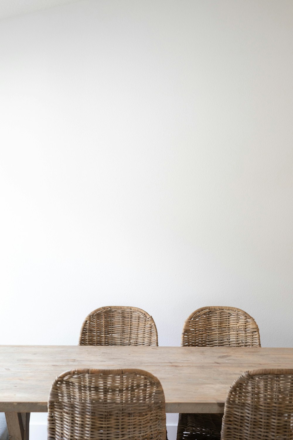 brown wicker chairs on white sand