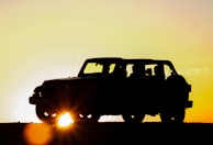Sunset casting warm light over the jeep and the Sidemen hills.