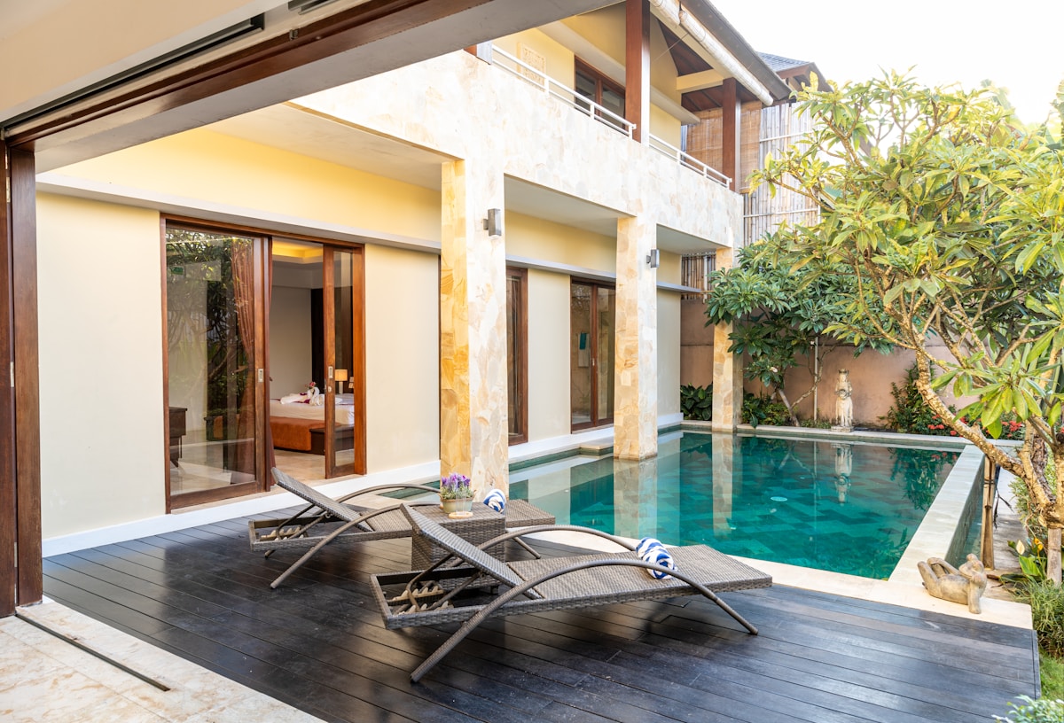 swimming pool with lounge chairs and tables